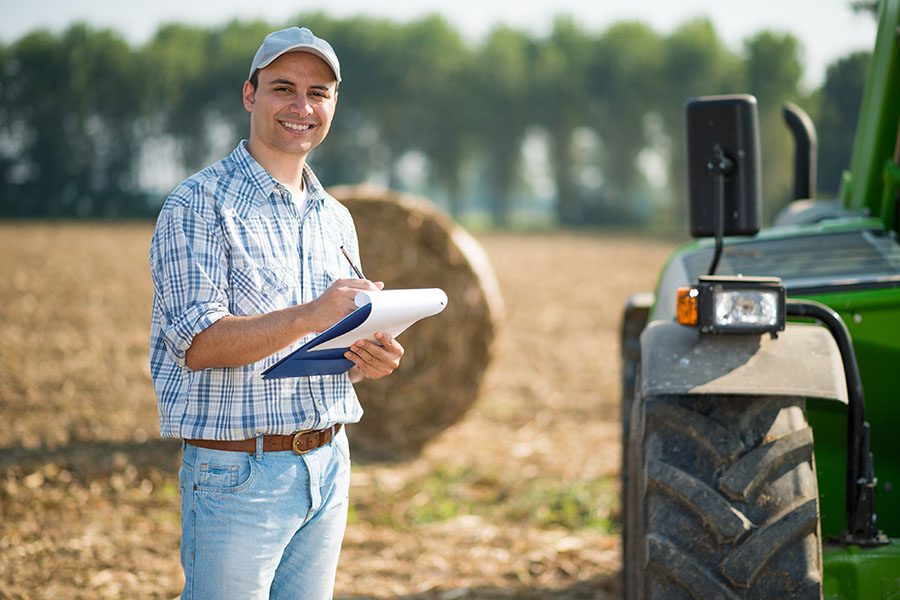 Business Insurance - Farmer Taking Notes On Field