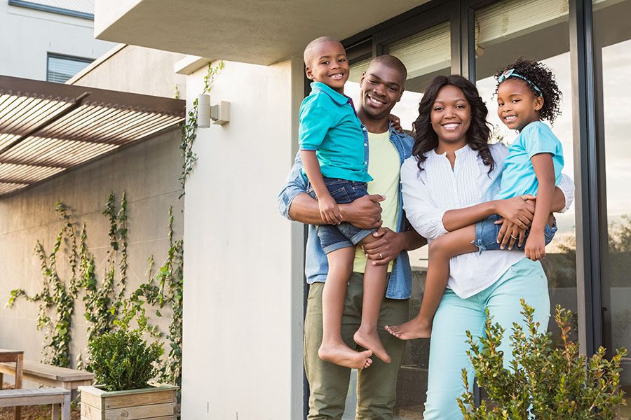Personal Insurance - Happy Family Standing Next To Home